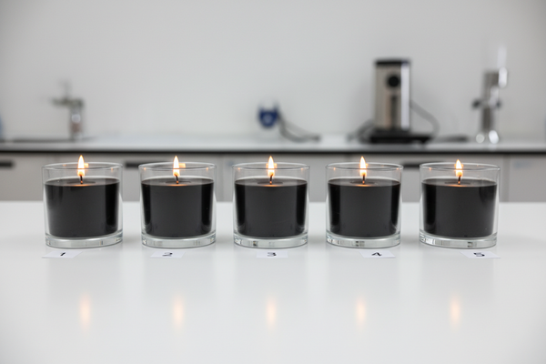 the glass is transparent and the candle wax is black. All of them are lightened and has 10 cm between each other